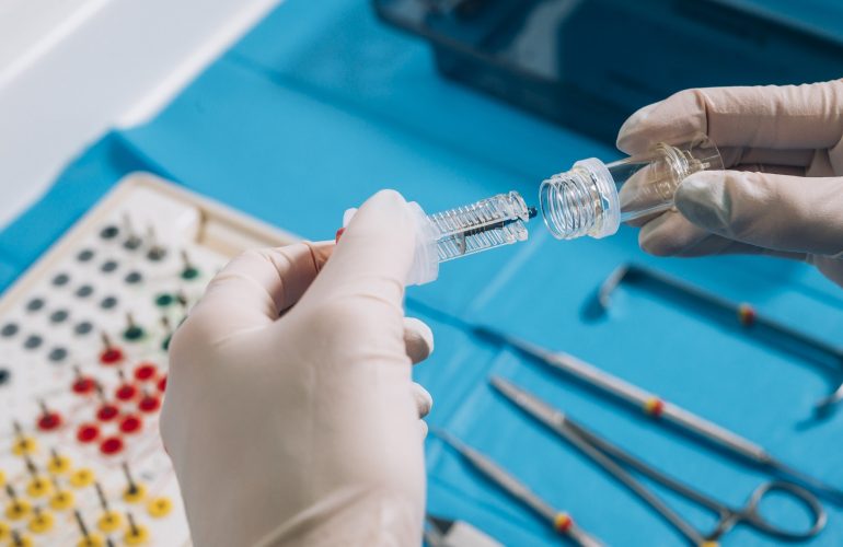 Hand holding a dental implant
